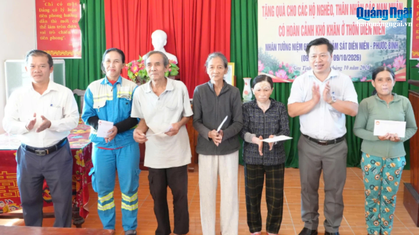 Đồng chí Nguyễn Hoàng Hiệp (thứ 2, bên phải) - Bí thư Đảng ủy xã Sơn Tịnh tặng quà hộ nghèo và các gia đình có nạn nhân trong vụ thảm sát Diên Niên - Phước Bình.